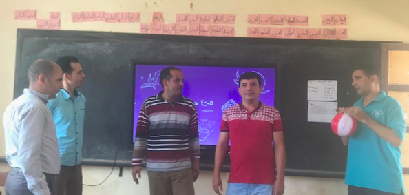 Abdelrahman Dawoud (2018-2019) and four workshop participants demonstrate a ball toss activity.