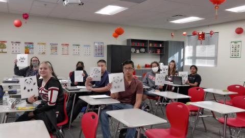 Students are showing their hand-made Bing Dwen Dwen, the mascot of the Beijing Winter Olympics