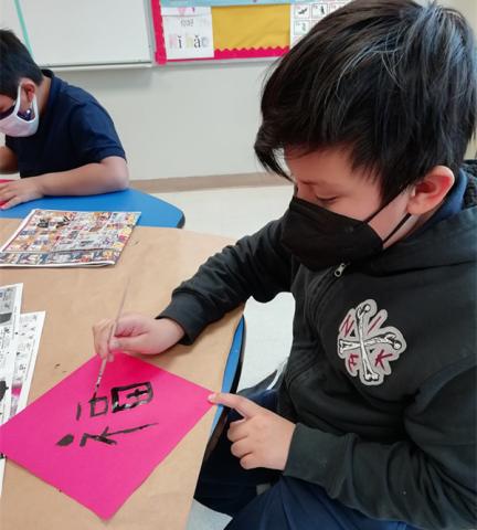 The students learn how to write Chinese character FU and decorate their classrooms with it when Chinese New Year is coming.
