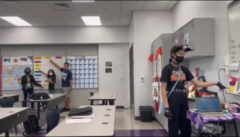 Students walk around the classroom to find the color