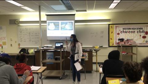 the teacher is teaching locations to describe the right position of classroom objects