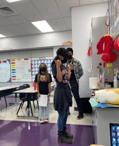 Students are playing the Blind Game to show directions