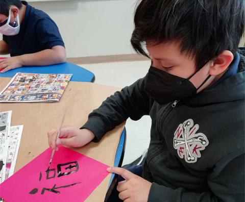 The students learn how to write Chinese character FU and decorate their classrooms with it when Chinese New Year is coming.