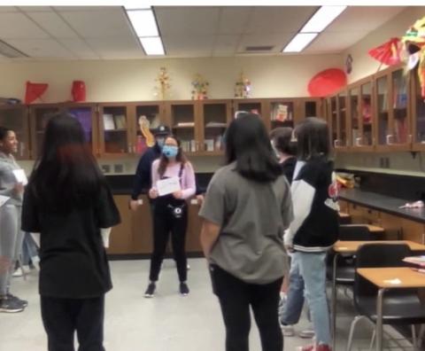 the teacher is leading the students to play a game about describing months in Chinese.