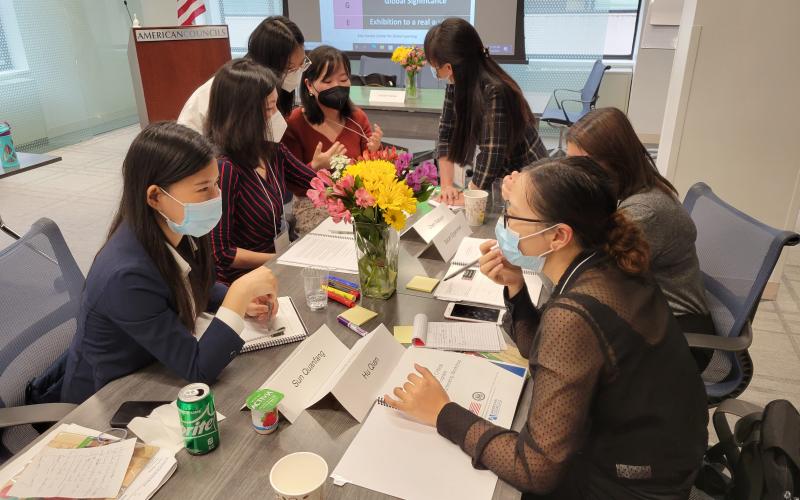 TCLP exchange teachers work as a group during a Spring Workshop session