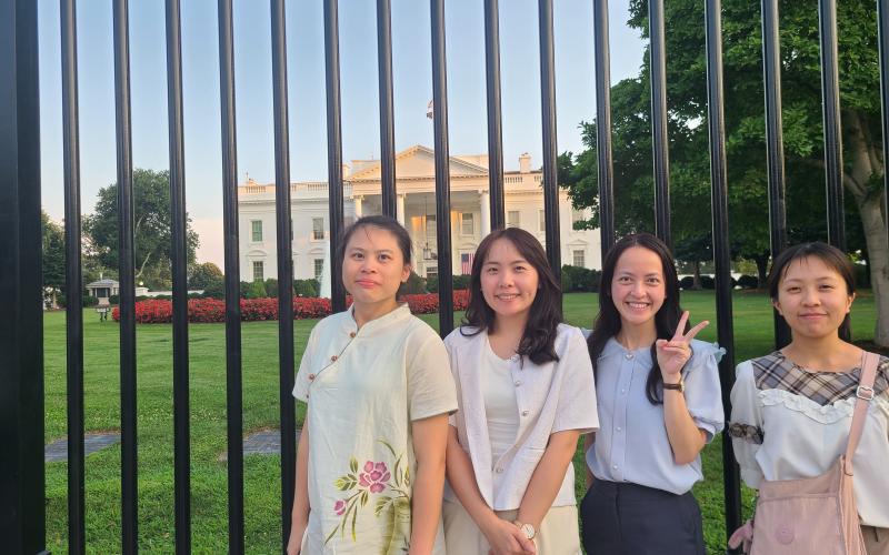 teachers pose in front of white house